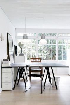 a dining room table and chairs in front of a large window with the word love written on it