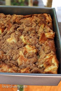 a casserole dish with apples and cinnamon crumbled toppings in a metal pan