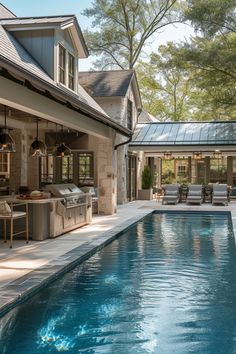 an outdoor kitchen next to a swimming pool