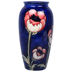 a blue vase with flowers painted on it