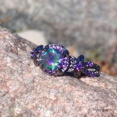 Beautiful Bamas Mystic Rainbow Topaz And Purple Amethyst Set In 10kt Black Gold Plated Flower Ring Brand New Size 8 In Stock Can Be Ordered In 6 Through 10 Upon Request 3 To 4 Weeks For Delivery Rainbow Topaz, Mystic Topaz Ring, Amethyst Set, Rainbow Rings, Mystic Topaz, Tiffany And Co, Flower Ring, Purple Amethyst, Purple Gold