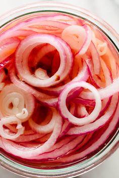 sliced onions in a glass bowl on a table