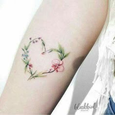 a woman with a flower tattoo on her arm