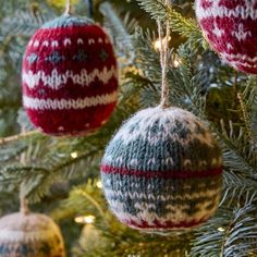 three knitted ornaments hanging from a christmas tree