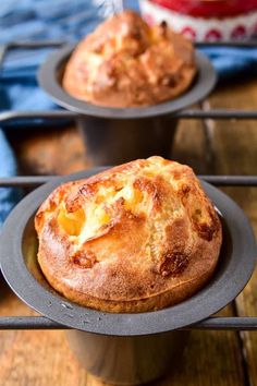 two muffins sitting on top of black plates