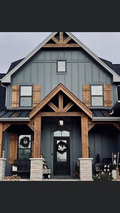 a large gray house with wooden trim and windows