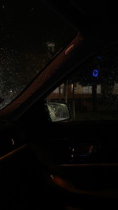 the inside of a car with rain on the windshield