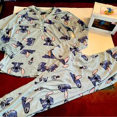 Adorable Two Piece Pajama Set Disney’s Stitch Design Size Women’s Small (4-6) Top And Bottom Pants In Preowned Good Condition Width (Armpit To Armpit): 19” Length Of Top (Top To Bottom): 22.5” Waist Of Pants (Side To Side): 15” (Elastic Waistband Will Expand Farther) Length Of Pants: 35” Disney Stitch Jewelry Tray New In Box Perfect For The Stitch Fan! Bundle Offers Welcome Disney Sleepwear With Character Print For Loungewear, Disney Character Print Sleepwear For Loungewear, Long Sleeve Disney Sleepwear For Bedtime, Disney Cotton Sleepwear For Loungewear, Disney Sleepwear With Cartoon Print For Sleepover, Disney Cartoon Print Sleepwear For Sleepover, Blue Character Print Sleepwear, Disney Cotton Sleepwear, Blue Character Print Sleepwear For Pajama Party