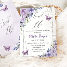 two wedding cards with purple flowers and butterflies on them, sitting next to each other