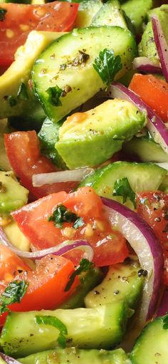 a salad with cucumbers, tomatoes and onions