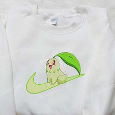 Chikorita x Nike Swoosh Anime Embroidered Hoodie, Pokemon Embroidered Shirt, Nike Inspired Embroidered Shirt Welcome to our exceptional clothing store, where style and fandom unite to bring you a captivating collection of custom embroidered apparel. We take great pride in offering a wide range of options, including embroidered sweatshirts, t-shirts, hoodies, and more. Among our standout pieces, you’ll find the enchanting Chikorita x Nike Swoosh anime embroidered hoodie, along with a variet Anime Nostalgia, Fandom Unite, Nike Inspired, Embroidered Apparel, Best Family Gifts, Nike Swoosh Logo, Unique Hoodies, Shirt Nike, Nike Brand