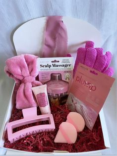 a pink gift box containing soaps, sponges and other items