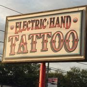 a sign that says electric hand tattoo on it