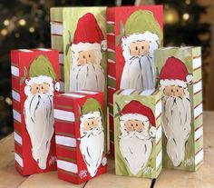 several bags with santa claus on them are sitting on a table next to a christmas tree