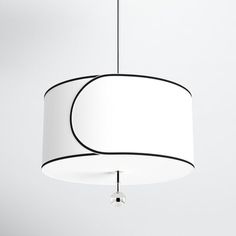 a white and black lamp hanging from a ceiling