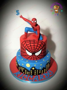 a spiderman birthday cake is on display