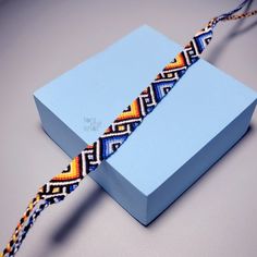 a blue box with a colorful braid on it