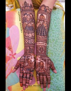 two hands with henna designs on them