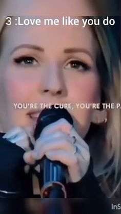 a woman singing into a microphone with the caption 3 love me like you do