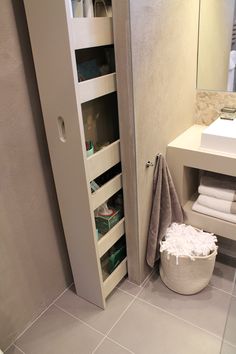 the bathroom is clean and ready to be used as a storage space for towels or other items