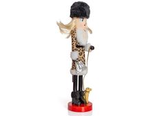 a figurine of a woman with a leopard print coat and hat holding a cane