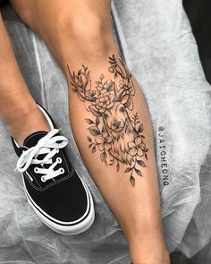 a woman's leg with a deer tattoo on it