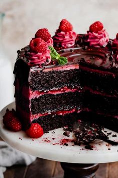 a chocolate cake with raspberry frosting on a plate