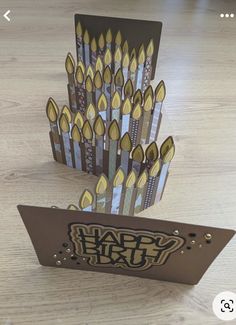 an open card with some yellow candles on it