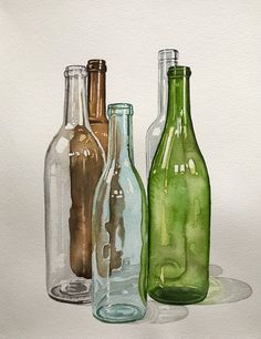 three different colored glass bottles sitting next to each other