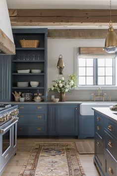 a kitchen with blue cabinets and an area rug