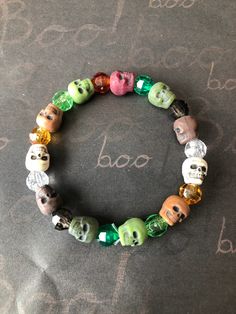 This is a Camouflage skull bracelet. It would make a great gift for Halloween. It would make a great addition to your Halloween costume. It has black, brown, green, and clear 8mm faceted beads. It has light and dark green, light and dark brown, and white skull beads. It was made with .8mm sturdy stretch string. I tie it several times to prevent breakage. It fits most teens and women. It stretches to fit on the wrist. All items are ready to be shipped I do combined shipping. Items ship in 2-5 bus Gifts For Halloween, Skull Beads, Halloween Bracelet, Halloween Beads, Skull Bracelet, Beaded Skull, Bracelets For Women, Green Dark, Halloween Skull