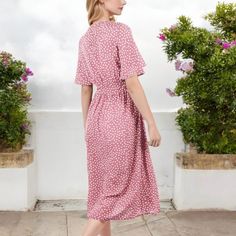 The Anna-Kaci Women's Polka Dot Midi Dress combines a playful polka dot print with timeless elegance. Featuring a stylish front tie detail and a button-front design, this dress offers a flattering silhouette that enhances your figure. The lightweight fabric and short sleeves make it comfortable for warm-weather wear, while the midi length adds a touch of sophistication. Ideal for casual outings, brunch dates, or special occasions, this versatile dress is a must-have for any wardrobe. Polka Dot Midi Dress With Short Sleeves For Vacation, Polka Dot Midi Dress With Buttons For Spring, Feminine Polka Dot Dress For Daywear, Polka Dot Summer Dress With Buttons, Summer Polka Dot Dress With Buttons, Polka Dot Spring Dress With Buttons, Polka Dot Dress With Buttons For Day Out, Polka Dot Midi Dress With Buttons, Knee-length Polka Dot Midi Dress For Vacation