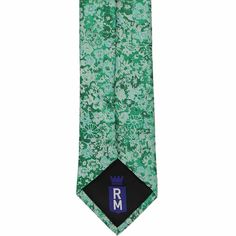 This green floral tie is a breath of fresh air for groomsmen attire and dressy spring events. Florals are trending, but this tie keeps things timeless thanks to the small and low-key all-green pattern. Let's talk about those green shades. There are a few lighter and darker hues in this pattern, from classic green to emerald, so it pairs well with many shades of green bridesmaid dress. For the rest of your ensemble, we really like this tie with navy blue or gray suits. (Don't forget to purchase t Elegant Spring Wedding Ties, Elegant Spring Ties For Groom, Dapper Spring Formal Ties, Dapper Formal Ties For Spring, Formal Spring Dapper Ties, Elegant Green Suit And Tie Accessories For Groom, Formal Adjustable Floral Print Suit Accessories, Floral Print Suit And Tie Accessories For Spring Business, Summer Wedding Ties For Groom