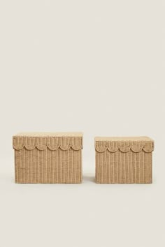 a pair of woven boxes with scalloped edges on the sides, sitting side by side