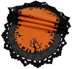 an orange and black placemat with halloween decorations on it, sitting in front of a white background