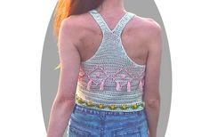 Get ready to make a statement in this comfy Oracle Crochet Top pattern! This beautiful tank top design features a racerback style with optional tassel detailing on the front. Wear this tank loose and relaxed or tie it up in the back with a hair tie for a more fitted look. Perfect for summer festivals or any boho-inspired occasion, the Oracle crop top is sure to turn heads. The pattern includes detailed instructions and step-by-step photos, making it easy to create your own stylish and comfortable top. This pattern is written in English with US terms Bust Measurement:30-34", 35-38", 39-42" Supplies:3.5mm hookFingering Weight YarnColor A: 400 yardsColor B: 150 yardsColor C: 70 yardsColor D: 100 Yarn Recommendation: Check out the yarn I used(affiliate link): Shop here There is no shipping cha Casual Sleeveless Top With Tassel Ties, Casual Spring Crochet Top With Tassels, Spring Festival Racerback Tank Top, The Oracle, Summer Festivals, Knit Picks, Crochet Top Pattern, Comfortable Tops, Boho Look