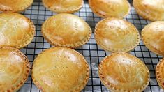 many small pies on a cooling rack ready to be baked in the oven for consumption