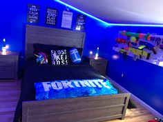 a bed room with a neatly made bed and blue walls