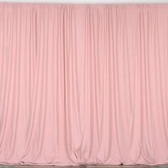 a pink curtain is hanging on the wall