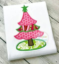 a christmas tree appliqued on a white shirt with pink and green accents