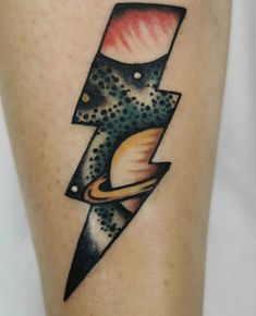 a tattoo on the leg of a person with a lightning bolt and saturn in it