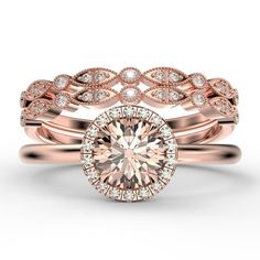 two rose gold wedding rings with an oval diamond center surrounded by small white and pink diamonds