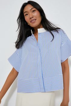 The White Sofia Shirt is the elevated style staple your closet needs. A short sleeve button down with a slightly cropped hem and a boxy silhouette that's perfect for pairing with all kinds of bottoms, this style is finished with contrasting blue and white stripes that add an extra-special detail to a classic look. Style with trousers and flats for the office, with a skirt and kitten heels for a dinner date, or with denim and crisp sneakers for weekend wear — this number can do it all. Stand coll Oxford Comma, Closet Needs, Fall Winter Trends, Elevated Style, Olympia Le Tan, Plus And Minus, Cocktail Attire, Dinner Date, Winter Trends