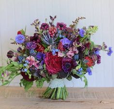 a bouquet of flowers sitting on top of a wooden table