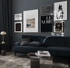 a living room filled with black furniture and pictures on the wall above it's coffee table