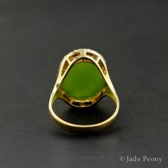 A natural piece that sparks conversation and energetic attraction, this Oval Statement Nephrite Jade Ring features a natural, untreated AAA nephrite jade stone of 11.75 carats. Surrounded in a halo setting with 0.07 carats of sparkling white diamonds and set in a four-prong setting, this statement ring also has classic features that allow it to remain timeless and versatile. Symbolizing wisdom and tranquility, this statement ring is set in a warm, high-quality 18kt yellow gold for endless adorat Green Opal Ring Spiritual Style, Green Opal Spiritual Ring, 35th Wedding Anniversary, Nephrite Jade, Halo Setting, Jade Ring, Jade Carving, Jade Stone, Black Spot