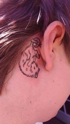 a close up of a person with a tattoo on their neck and behind the ear