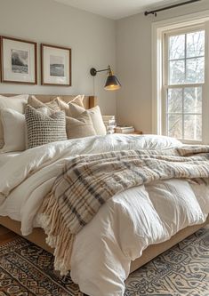 a large bed sitting next to a window in a bedroom on top of a rug