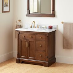 a bathroom vanity with a mirror above it