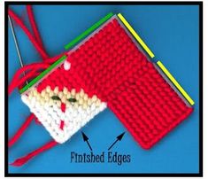 a crocheted red and white purse with green trimmings on the side